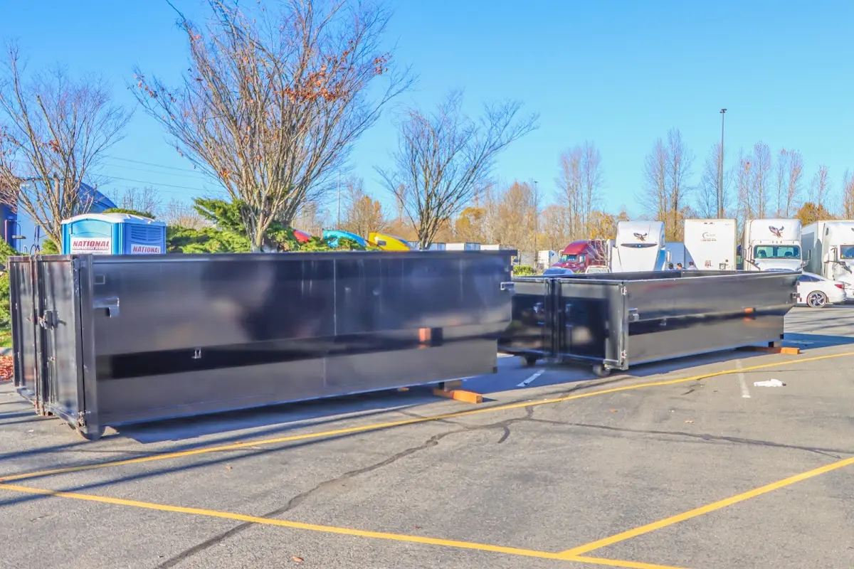 Professional dumpster rental service with roll-off container on residential driveway in Ewing